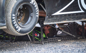 Strickler works underneath car