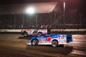 Chris Madden and Brandon Sheppard race for position