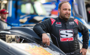 Donny Schatz stands next to his Late Model