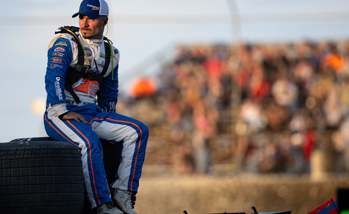 Logan Schuchart sits atop a tire