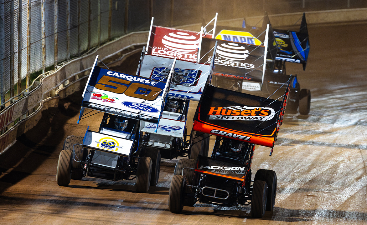 A pack of World of Outlaws NOS Energy Drink Sprint Cars racing led by David Gravel