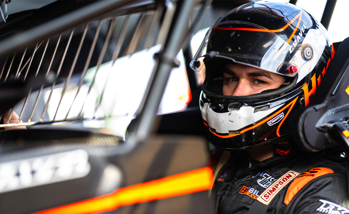 David Gravel sits in the Big Game Motorsports #2 with his helmet on and visor up