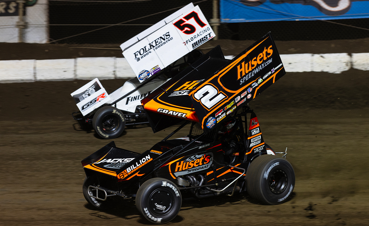 David Gravel races underneath Kyle Larson at Jacksonville