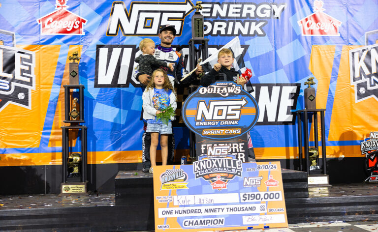 Kyle Larson stands in Knoxville Raceway Victory Lane