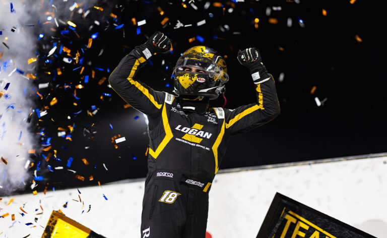 Gio Scelzi does a wing dance with his helmet on in Knoxville Victory Lane