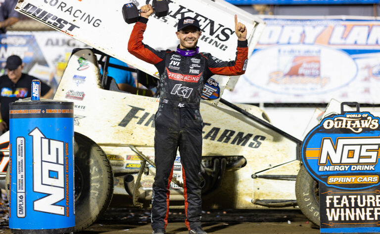 Kyle Larson holds up the Ironman 55 dumbbell trophy in I-55 Victory Lane
