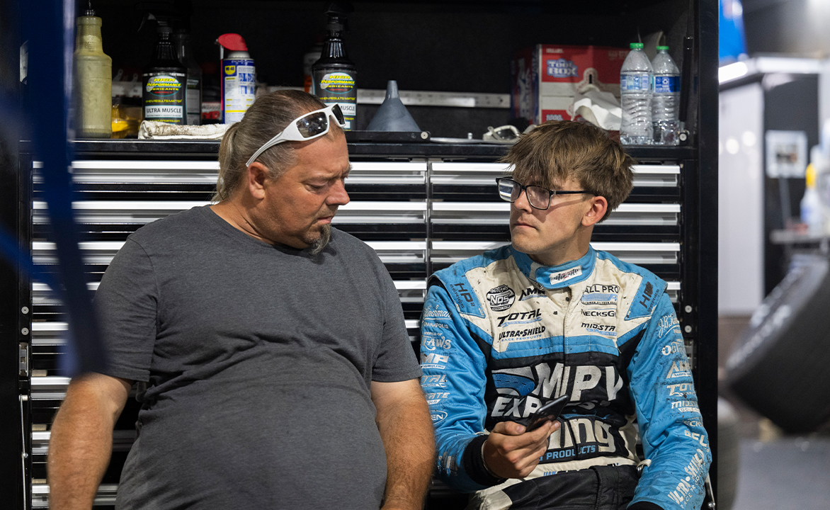 Landon Crawley sitting next to Jason Sides on their pit mule