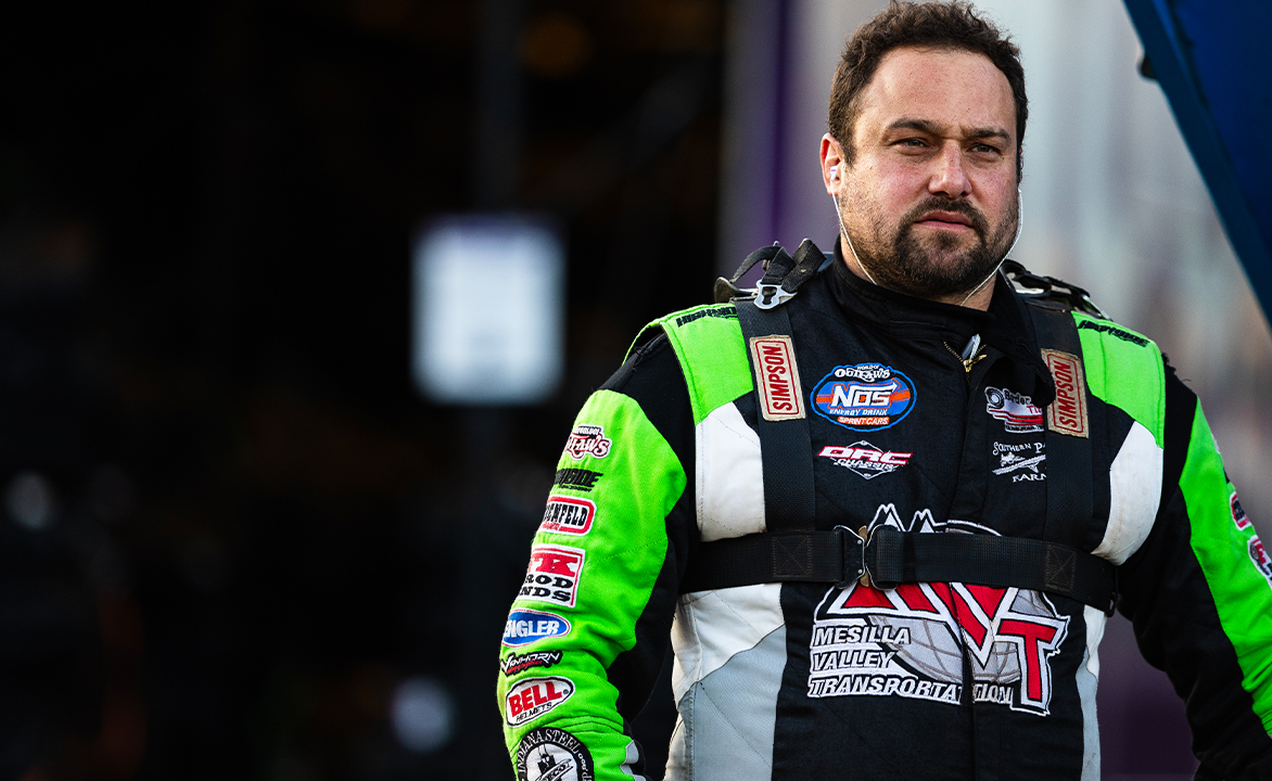 Kraig Kinser stands in his fire suit