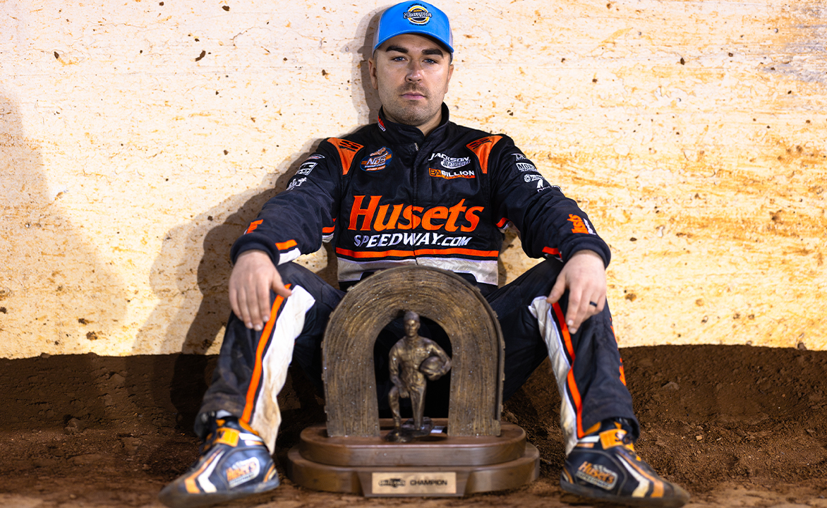David Gravel sits with the World of Outlaws championship trophy between his legs