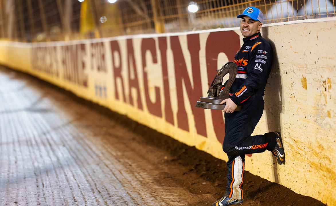 David Gravel stands with the World of Outlaws championship trophy