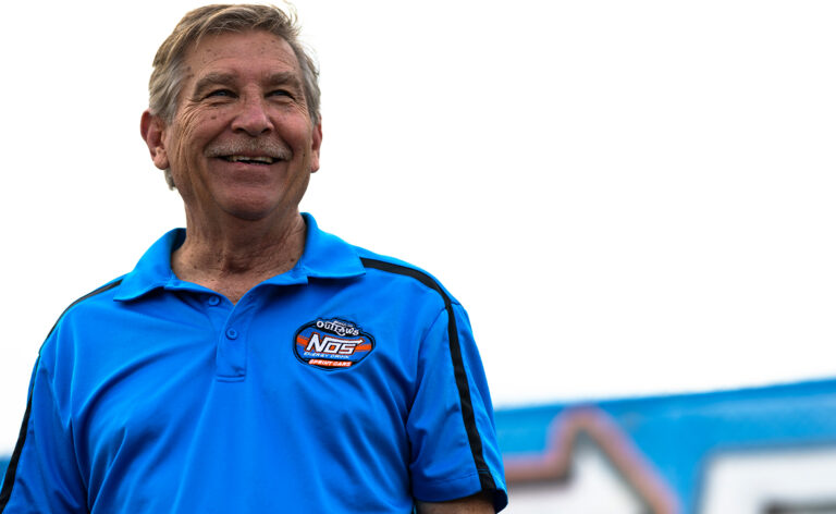 Carlton Reimers smiling in a World of Outlaws polo shirt