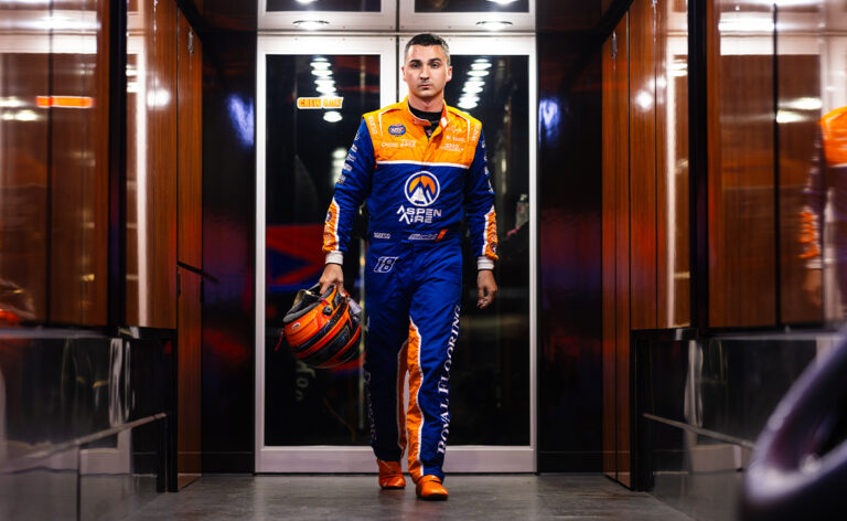 Gio Scelzi walking in the KCP Racing trailer