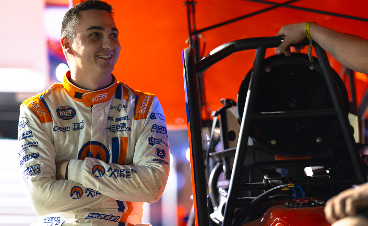 Gio Scelzi stands next to the KCP Racing No. 18 Sprint Car