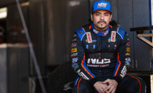 Chris Windom sitting in the Sides Motorsports trailer