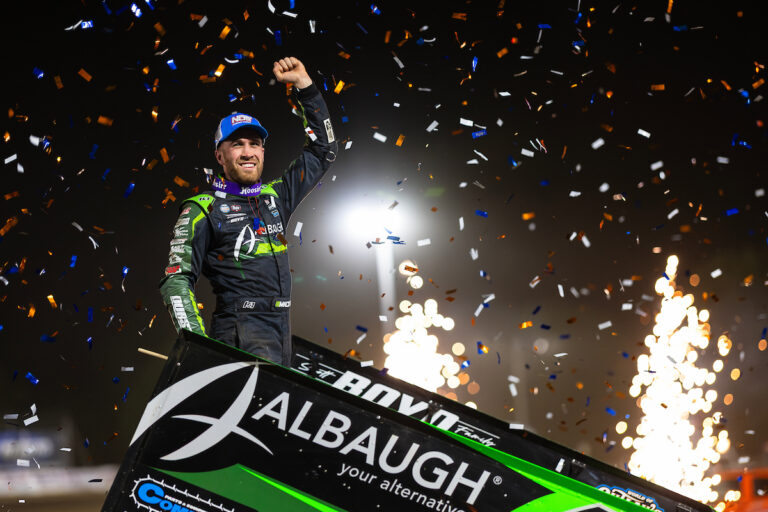 World of Outlaws Sprint Car driver Carson Macedo celebrating atop his car in Atomic Speedway Victory Lane