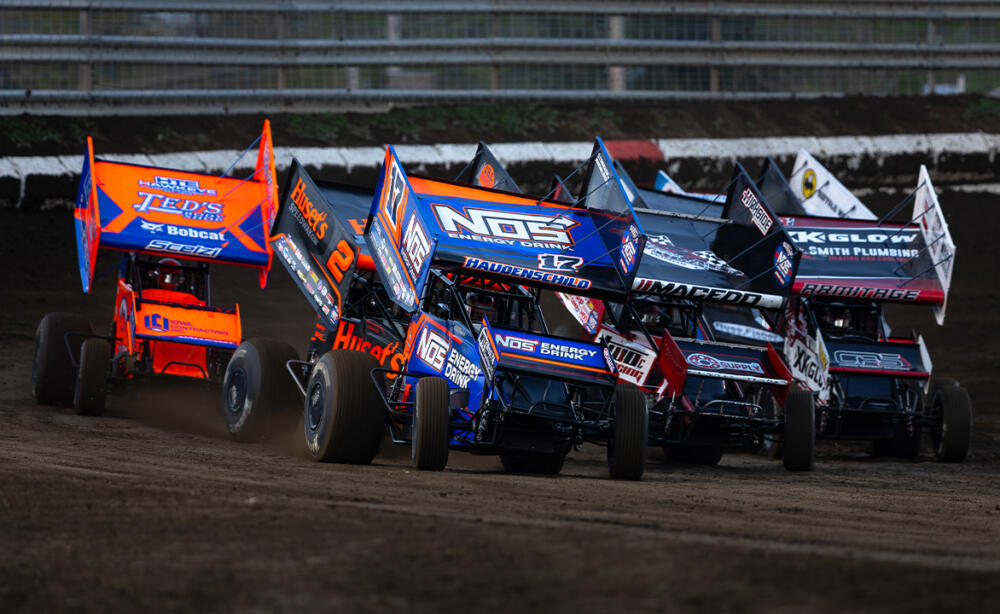 A pack of World of Outlaws Sprint Cars racing