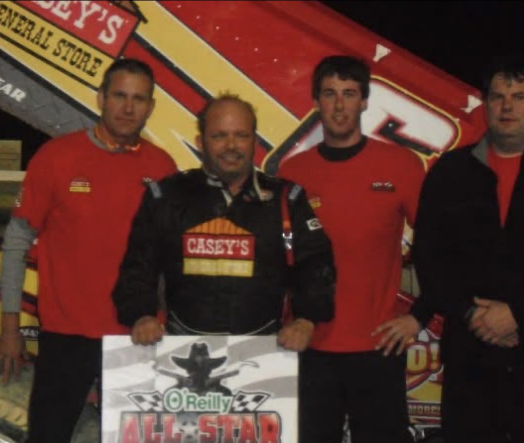 Pete Stephens stands with Danny Lasoski, Cody Jacobs, and Barry Jackson in Victory Lane