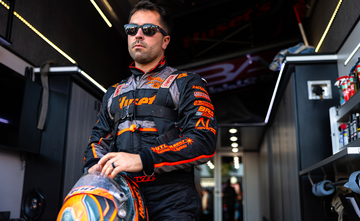 David Gravel in his fire suit holding his helmet