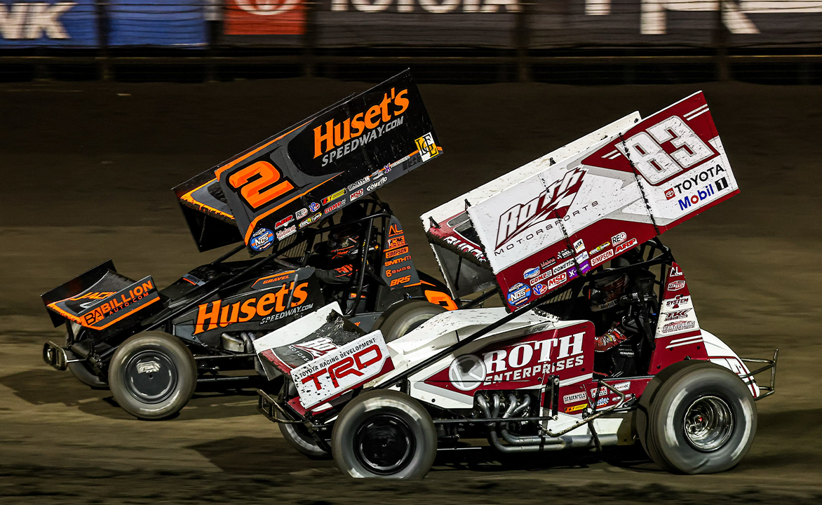 Buddy Kofoid racing alongside David Gravel at Huset's Speedway
