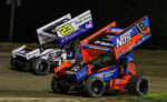 Sheldon Haudenschild racing alongside Garet Williamson at Wilmot Raceway