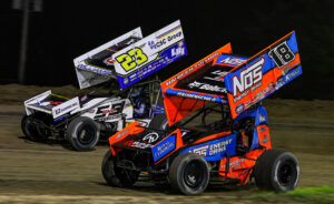 Sheldon Haudenschild racing alongside Garet Williamson at Wilmot Raceway